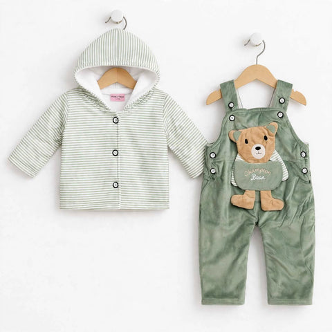 A baby clothing set displayed on wooden hangers against a white background, featuring a light green and white striped hooded cardigan and sage green corduroy overalls with a teddy bear applique.