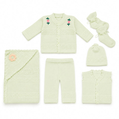 A 6-piece baby knit clothing set in pale mint green, featuring a long-sleeve cardigan with embroidered flowers, matching pants, a folded blanket with a flower applique, a beanie, booties, and a sleeveless vest, all arranged on a white background.