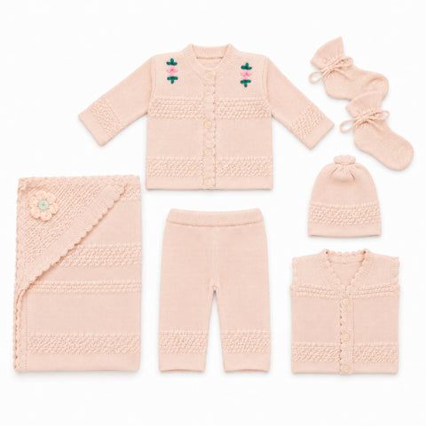 A coordinated baby knit clothing set laid out on a white background, including a long-sleeve cardigan with embroidered floral details, matching pants, a hat, a folded cardigan, a pair of booties, and a knitted blanket.