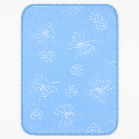 A rectangular baby blanket with rounded corners, featuring a light blue textured fabric with a white pattern of butterflies, flowers, and leaves, finished with a stitched border.