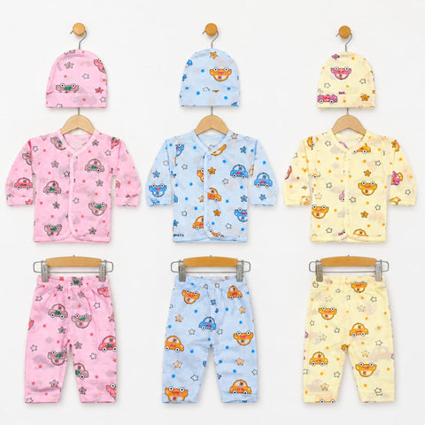 Six baby clothing sets displayed on wooden hangers against a white background, each set including a hat and matching outfit in pink, light blue, or pale yellow. The garments feature playful cartoon patterns of cars, stars, and mushrooms.