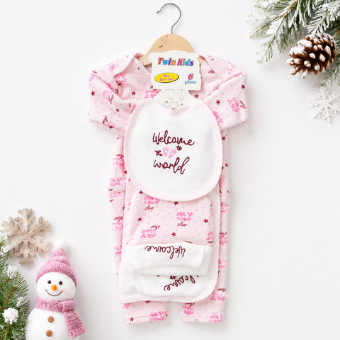 A baby sleep suit set with a bib, hanging on a wooden hanger. The set includes a light pink long-sleeve sleep suit with small dark pink star and snowman patterns, a white bib with 'Welcome to the world' printed in dark pink, and a matching white foot warm