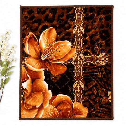 A rectangular area rug with a brown and black leopard print background, featuring large orange-brown floral motifs and an ornate vertical gold-toned decorative motif. The rug is shown flat against a white background with a small decorative plant branch at