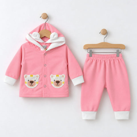 A baby clothing set consisting of a pink hooded cardigan and matching pants, displayed on wooden hangers against a plain white background. The cardigan features a white hood with bear ears, snap-button front, and two bear-face patches on the front.