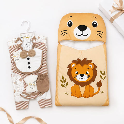 A baby gift set featuring a lion-themed sleeping bag and a matching baby outfit. The sleeping bag is light beige with a cartoon lion graphic and a matching lion-head hood.