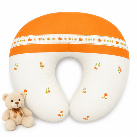 An U-shaped baby nursing pillow in orange and white with a small floral pattern, shown on a white background with a small teddy bear toy.
