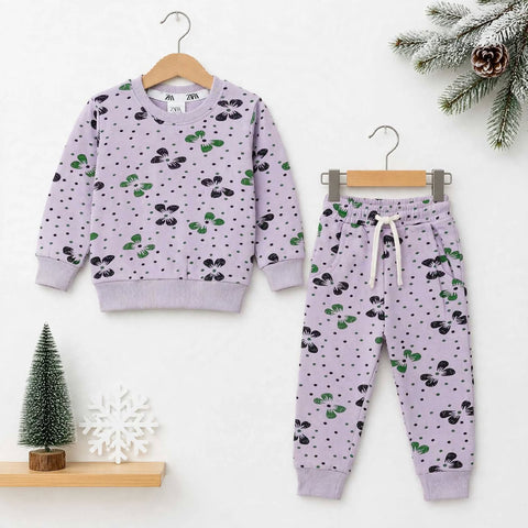 A children's two-piece knit outfit set in light lavender purple, featuring a long-sleeve sweatshirt and matching jogger pants. The set is decorated with a repeating pattern of black and green cherry blossoms and small black dots.