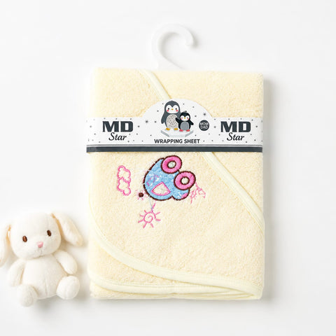 A pale yellow MD Star wrapping sheet for a baby hooded towel, displayed on a white hanger with a small plush bunny toy next to it on a white background.