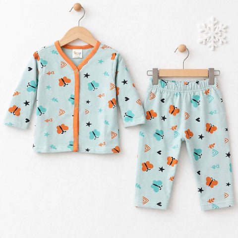 A baby two-piece pajama set consisting of a long-sleeve cardigan and matching pants, displayed on wooden hangers against a white wall. The pajamas feature a light mint green base with a colorful cartoon pattern of orange butterflies, teal birds, and black