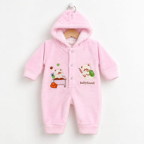 A pink hooded baby jumpsuit with a plush fleece texture, featuring cartoon bear graphics and the text 'babyfound' on the front, hanging on a wooden hanger against a plain white background.
