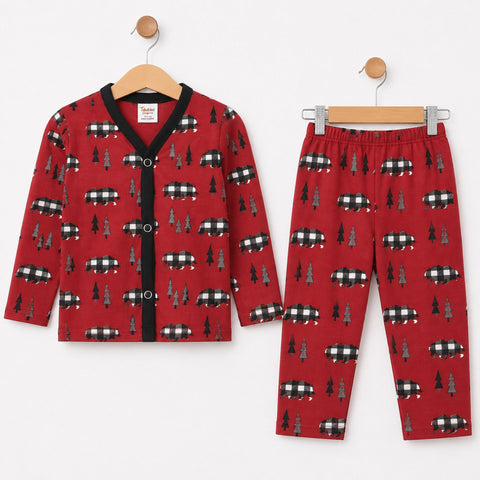 A two-piece children's pajama set including a long-sleeve button-front cardigan and matching pants, both in red with a repeating pattern of black-and-white buffalo plaid logs and dark green pine trees, displayed on wooden hangers against a white backgroun