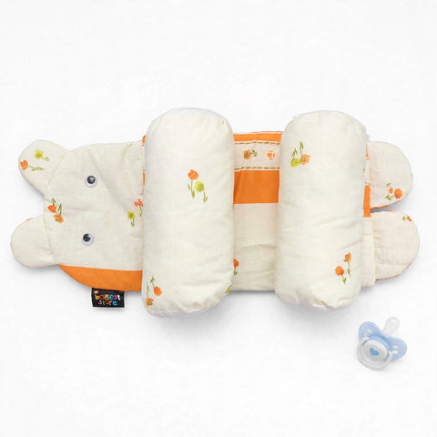 A baby sleep support pillow set by Great Sleep, featuring a white and orange bear-shaped design with floral accents, shown with a blue pacifier on a white background.
