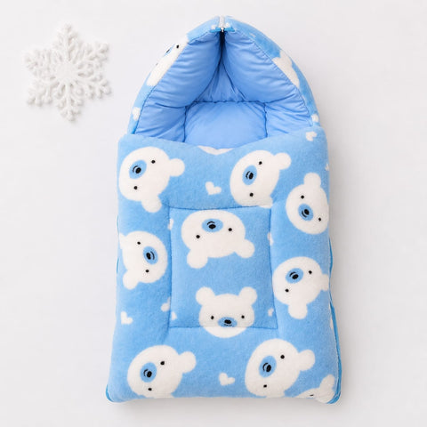 A light blue fleece baby footmuff or sleeping bag with a white polar bear pattern, shown on a white background with a small white snowflake prop in the top left corner.